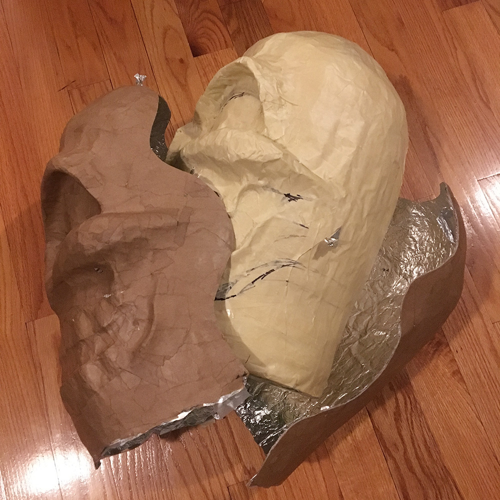 Twin paper mache skull masks - slicing open the paper mache