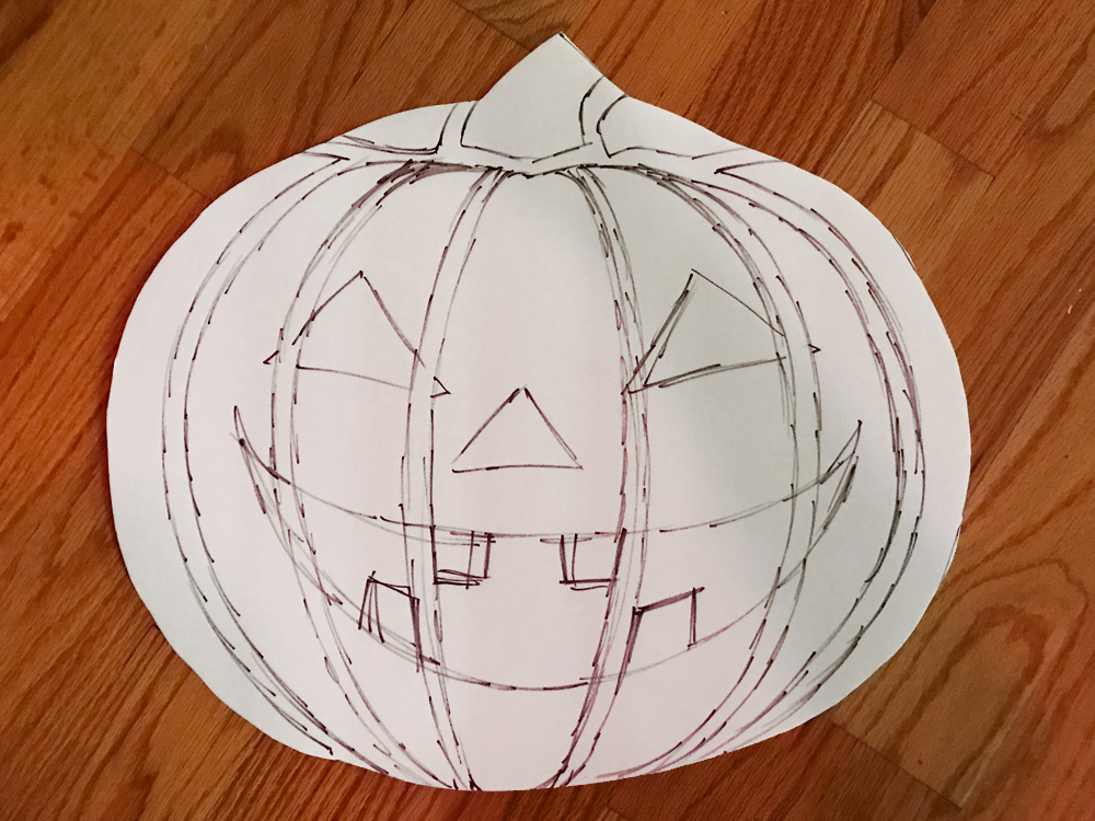 Paper mache jack o' lantern lollipop prop - drawing the face