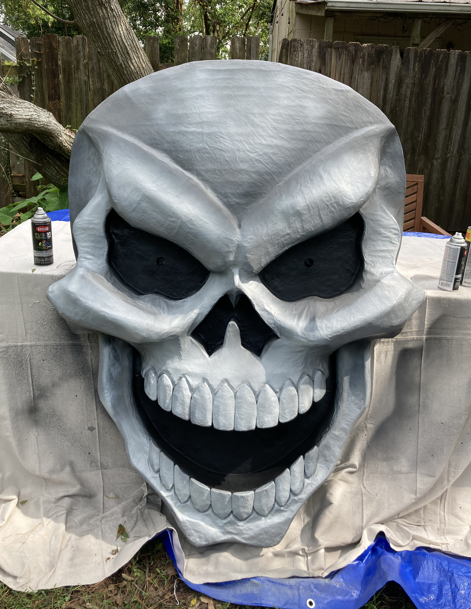 Giant paper maché skull Halloween decoration - spray paint