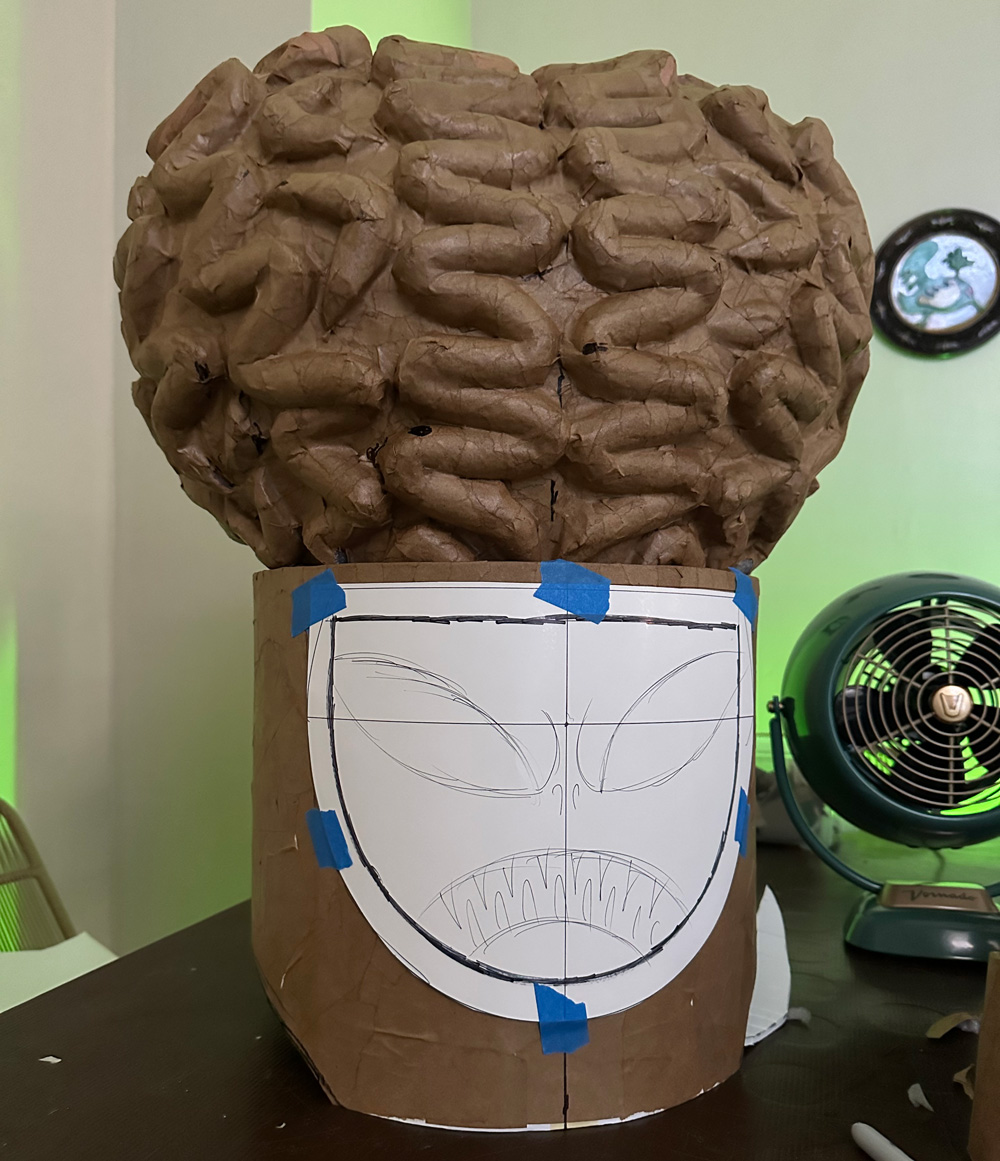 Covering the brain with paper mache, and drawing the alien face