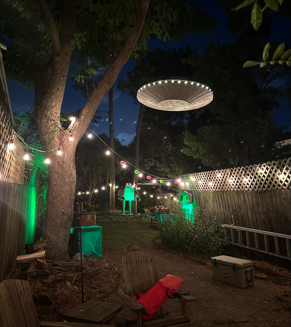 The UFO, lit up and hanging from a treet at night