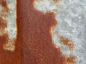 Orange brown rust on light gray metal