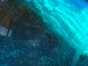 Sunlight shining through a blue glass blob