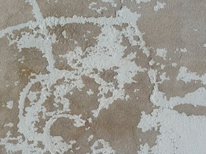 Scraped paint on a concrete wall