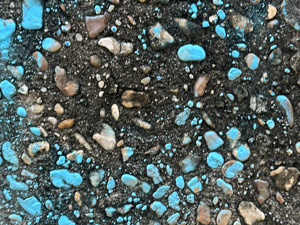 Pebbles in cement; some are painted blue
