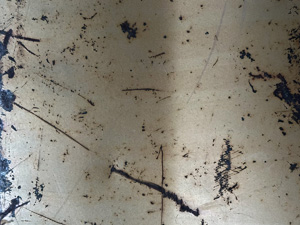 White painted metal surface with dark scratches
