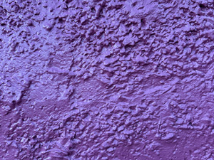 Shiny purple painted rough cement surface