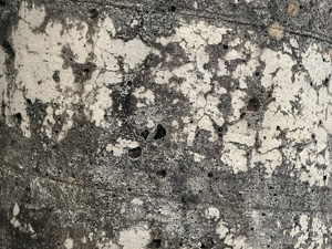 Weathered paint on a concrete post