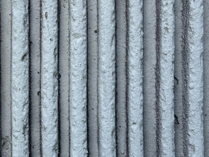 Vertical ridges in white concrete