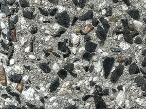 Tiny black and white rocks embedded in concrete