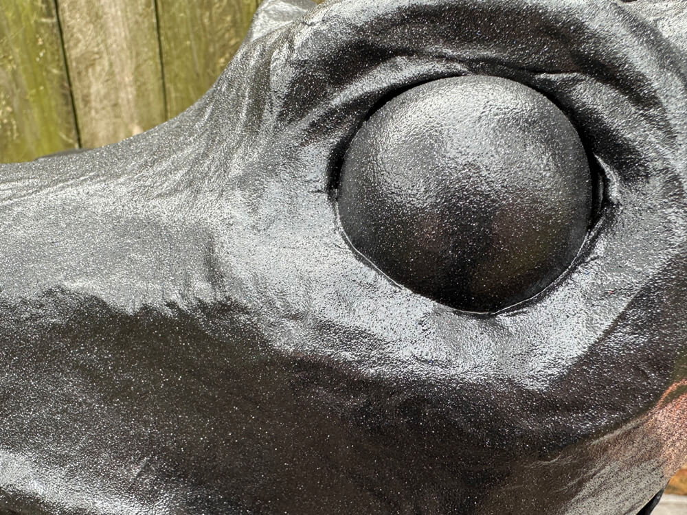 close up of black paint and black glitter on one of the eyes