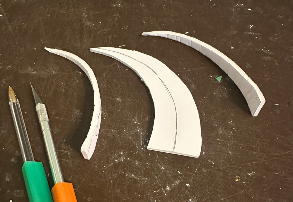 Cutting out the horn shapes from foam core