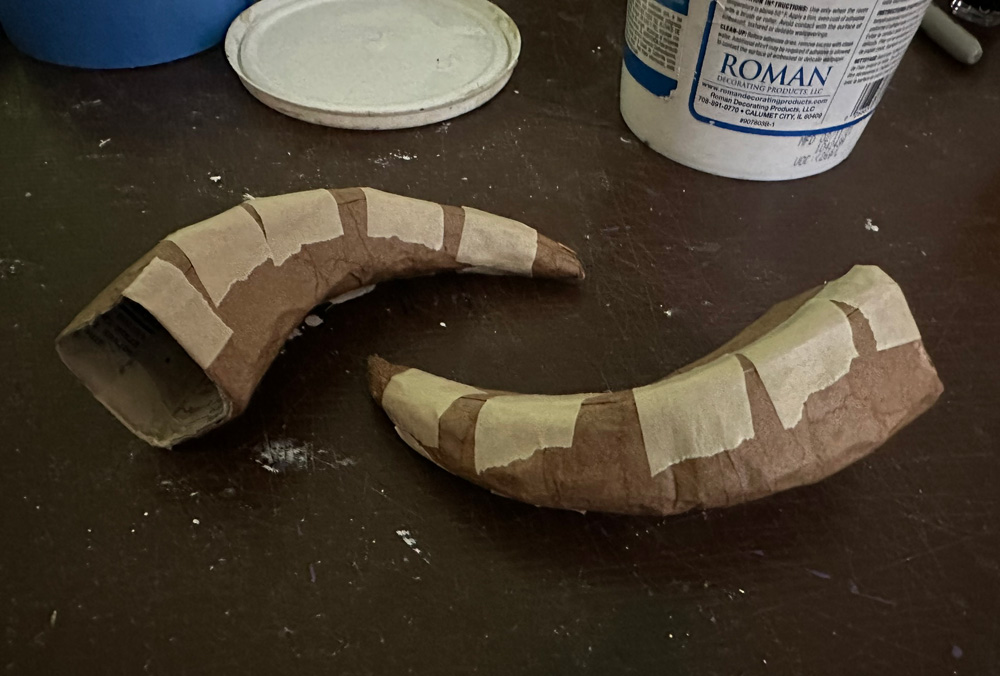 Closing up the paper mach&eacute; horns with masking tape