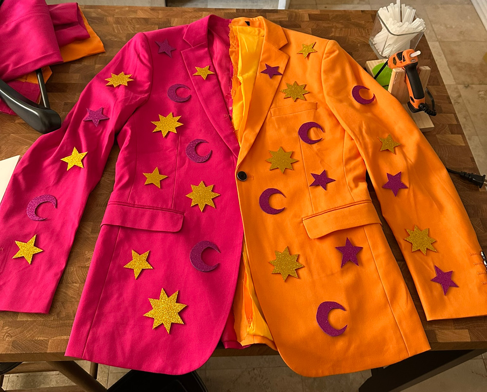 The front of the jacket, magenta on the left, orange on the right, with little stars and suns and moons glued all over.