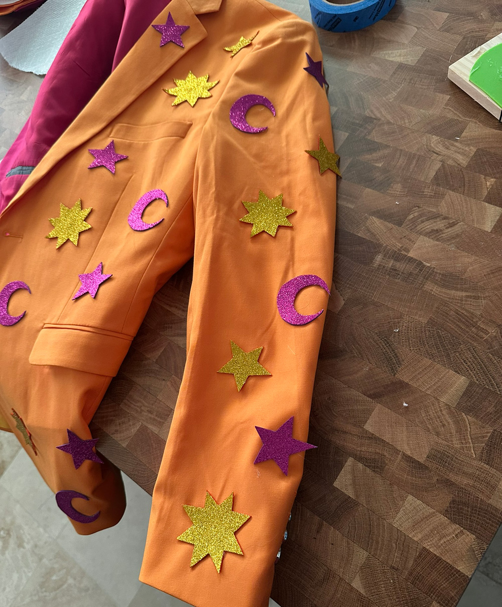 Closeup of the orange sleeve showing the little glittery suns and moons and stars.