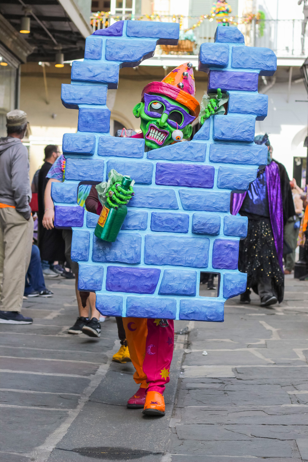 Full body shot of me in my costume; I'm walking toward the camera with most of my body concealed behind the fake wall prop.
