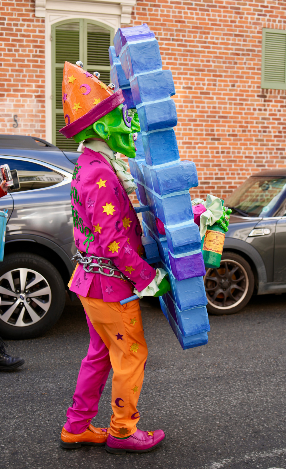 A side view of me walking in my costume; my hands are holding onto handles behind the wall at waist height.