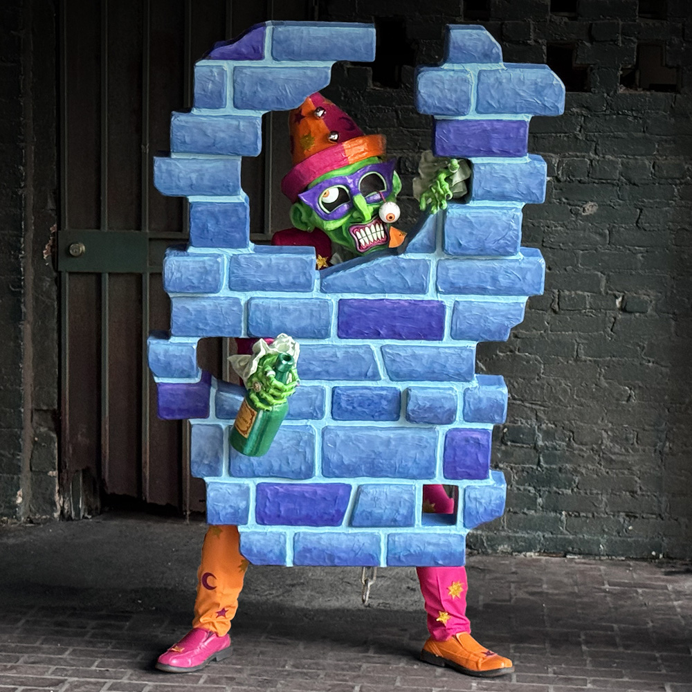 Posing with my costume in front of a dark wall.