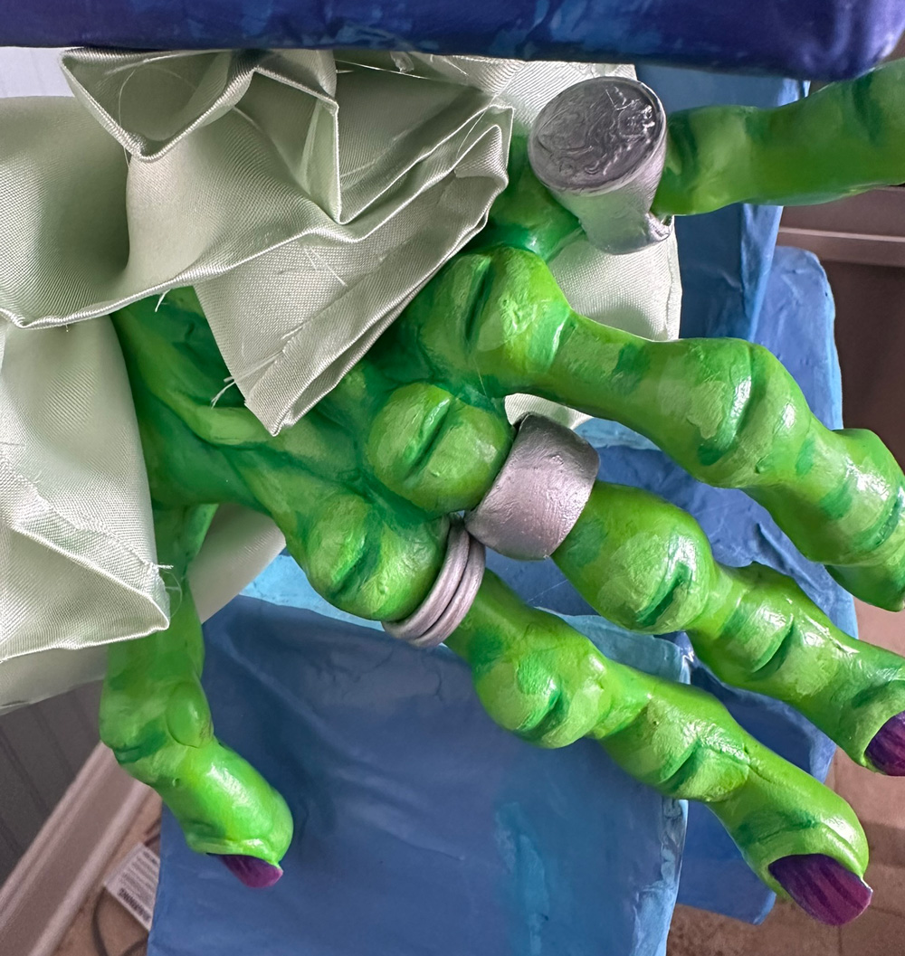 The other zombie hand perched in its place in the other hole in the blue brick wall