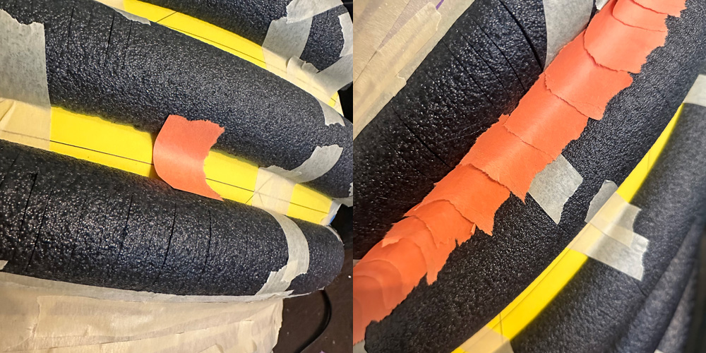 Close up of pieces of construction paper between the black foam tubes.