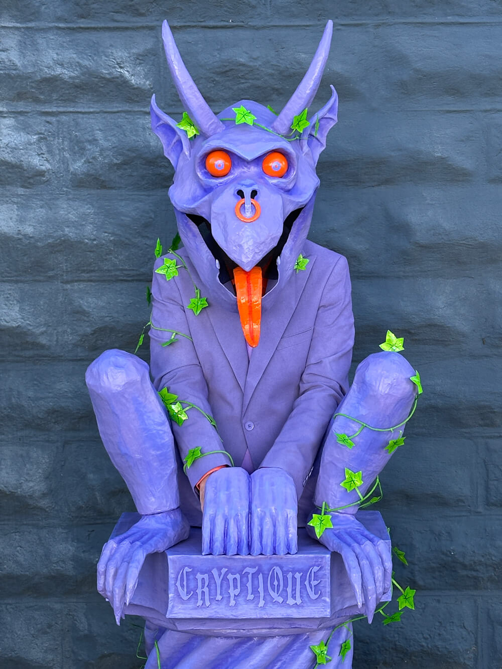 Close up of the finished gargoyle costume; it's all purple with orange eyes, tongue, and nose ring.