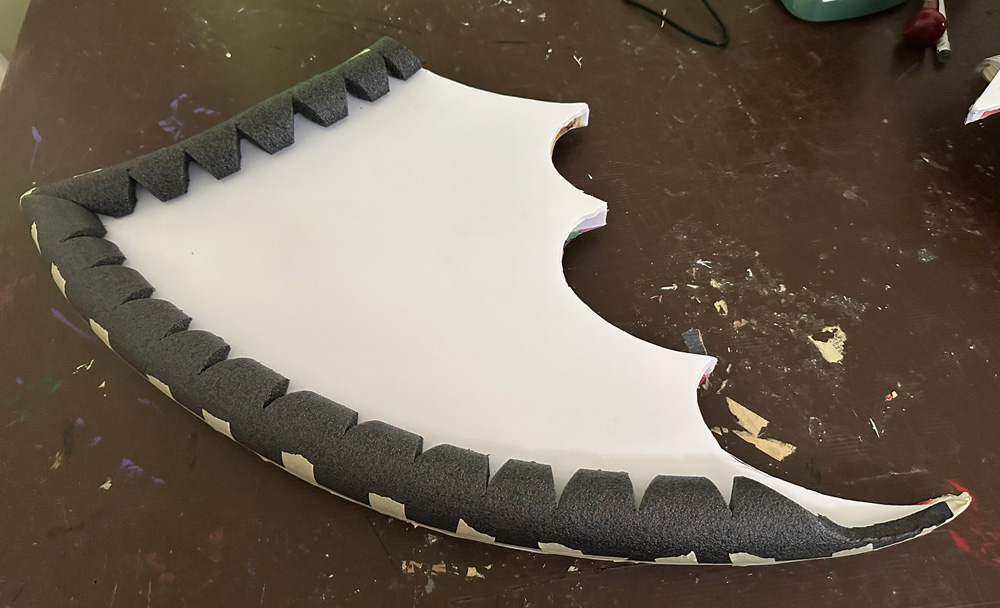 Pieces of foam insultation tubing taped in place along the outer edge of the back of the wings