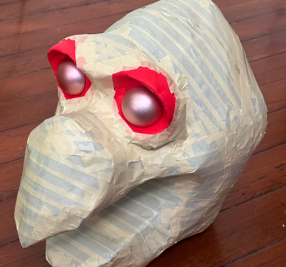 Building up foam eyebrow ridges around Christmas ornament eyeballs
