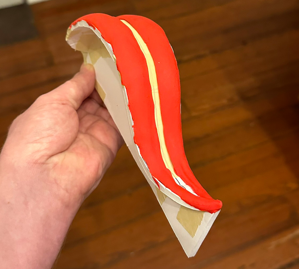Front view of the tongue showing the red foam clay that's built up on both sides, leaving a groove in the middle
