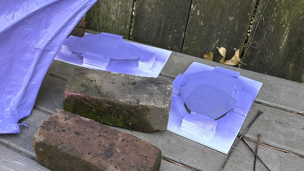 The pieces of screen have been spray-painted purple.