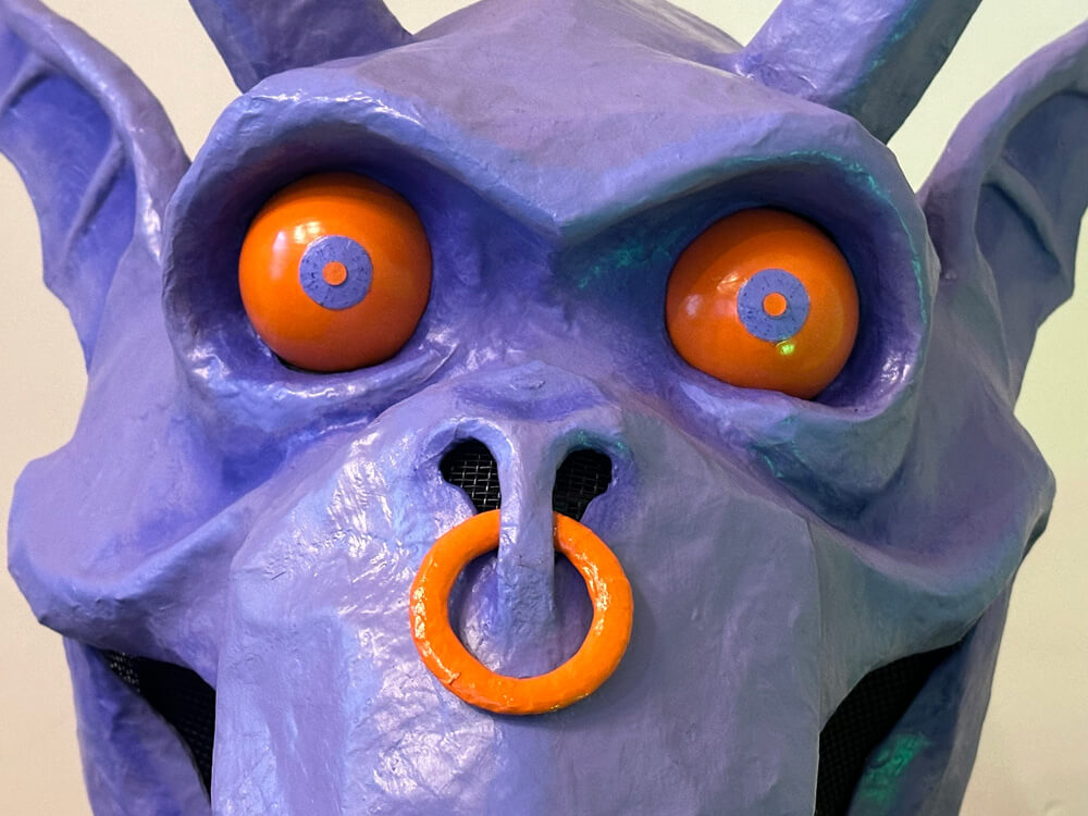 Close-up of the gargoyle's eyes and nose with nose ring.