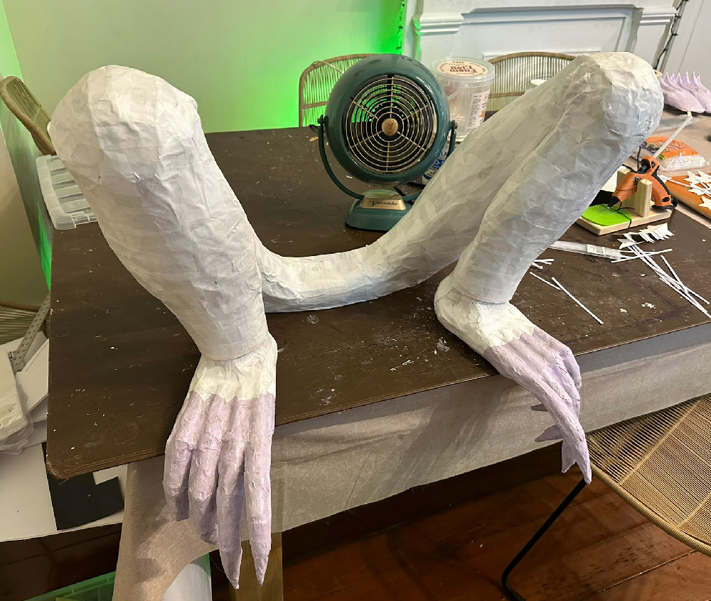The legs are now covered in white paper mache.
