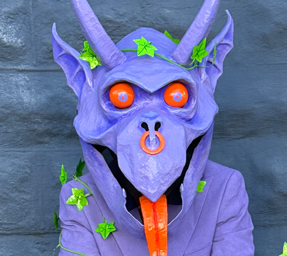 Close up of my purple gargoyle mask showing a wreath of ivy on top of the head.