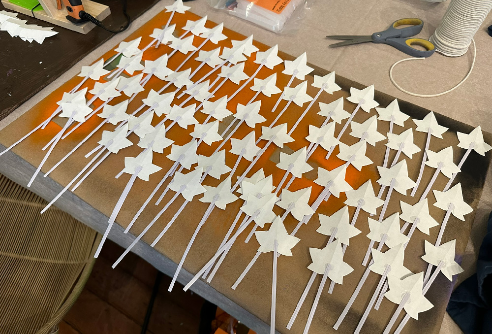 Many white paper leaves attached to white twist ties.