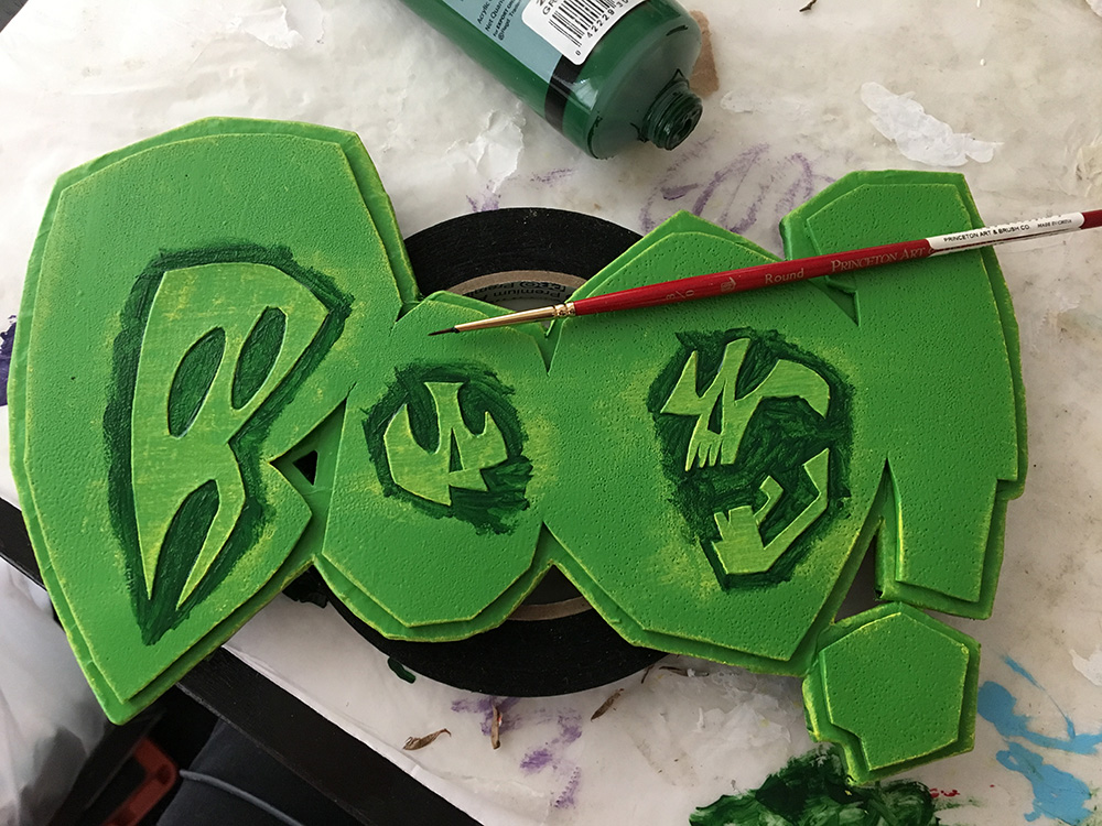 Haunted book sculpture - painting the BOO! logo