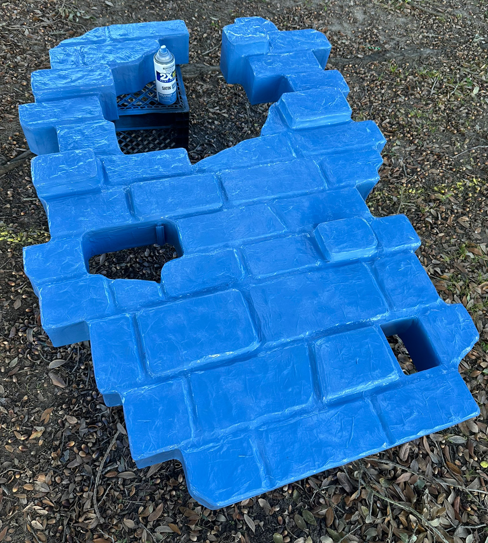 Spray painting the wall blue