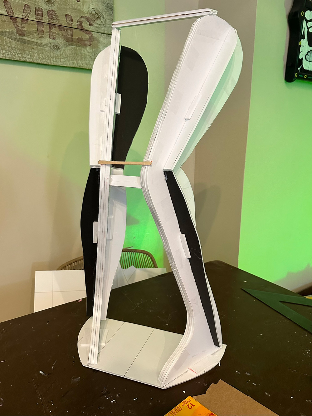 A pair of simple legs made of foam board panels, standing up