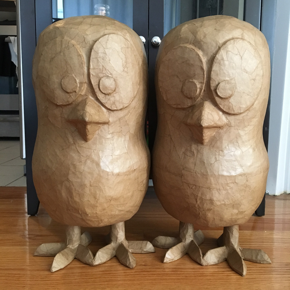 Baby chicks sculptures covered in brown paper mache, not yet painted.