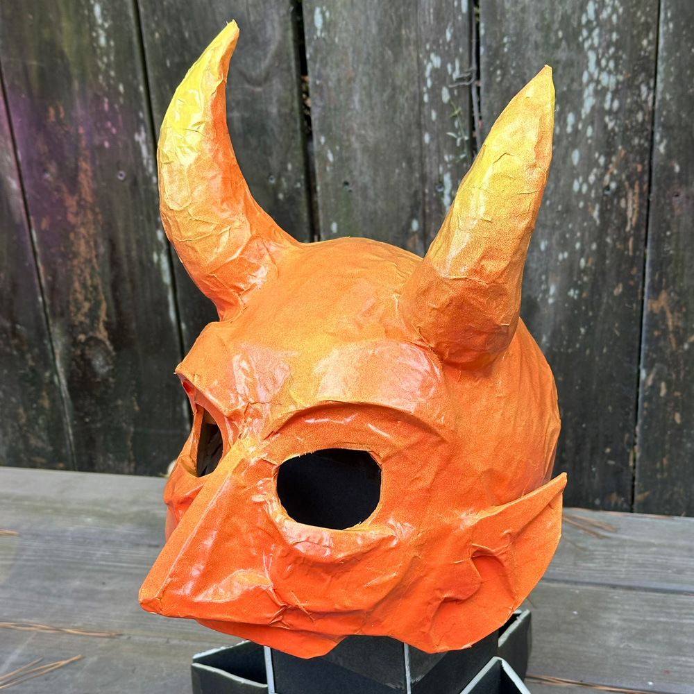 The mask is now spray painted solid orange.