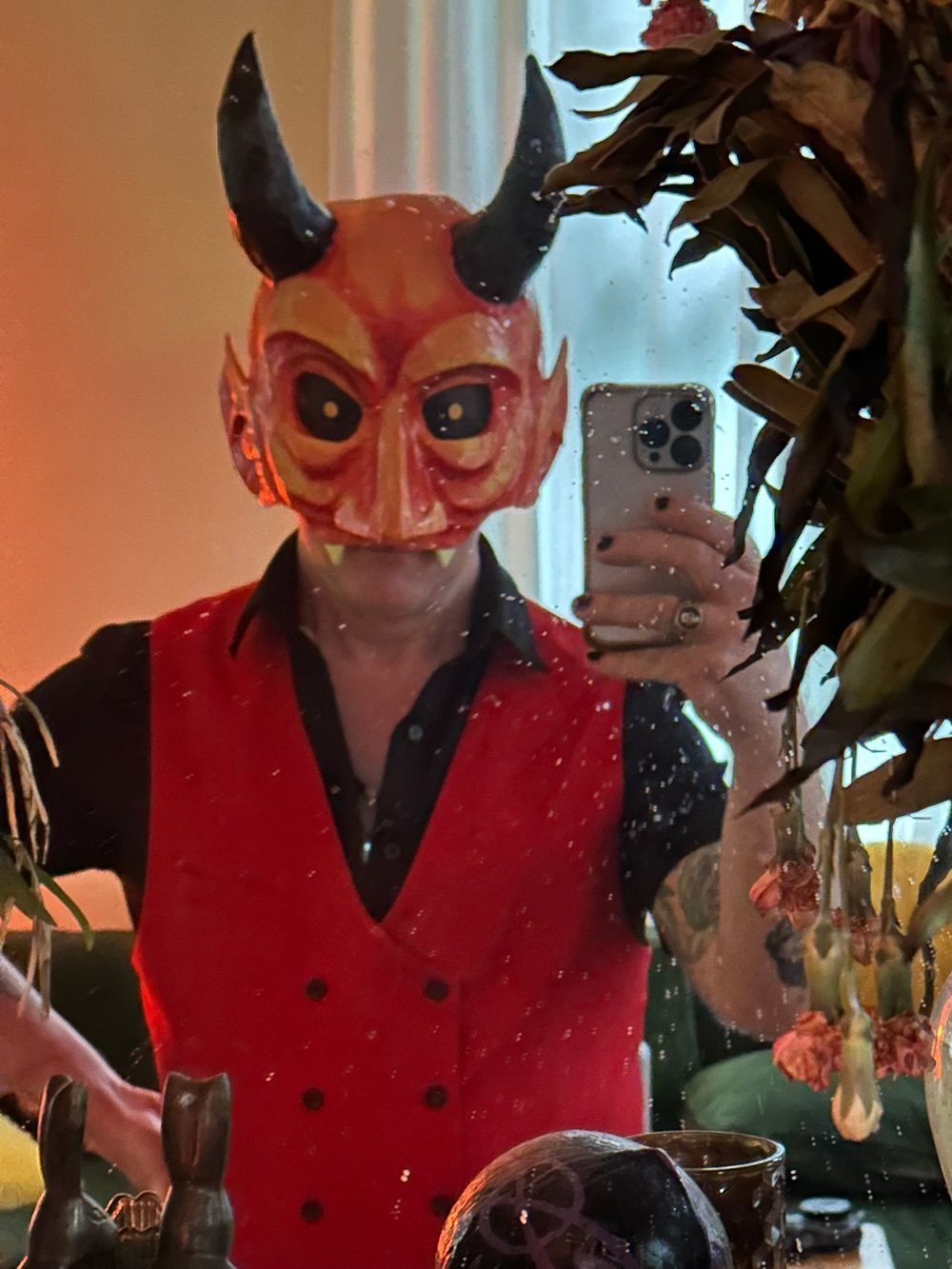 Me wearing the mask along with a black shirt and red vest.