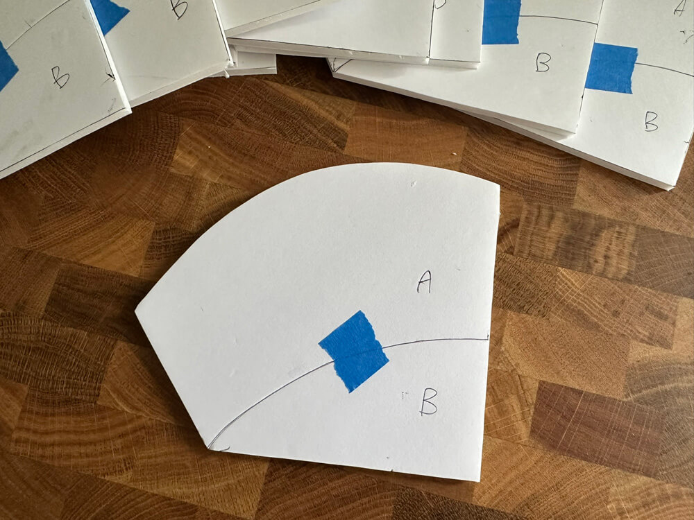 One of the foam board pumpkin lid shapes, with letter A at the top and B at the bottom and a curved line dividing them.
