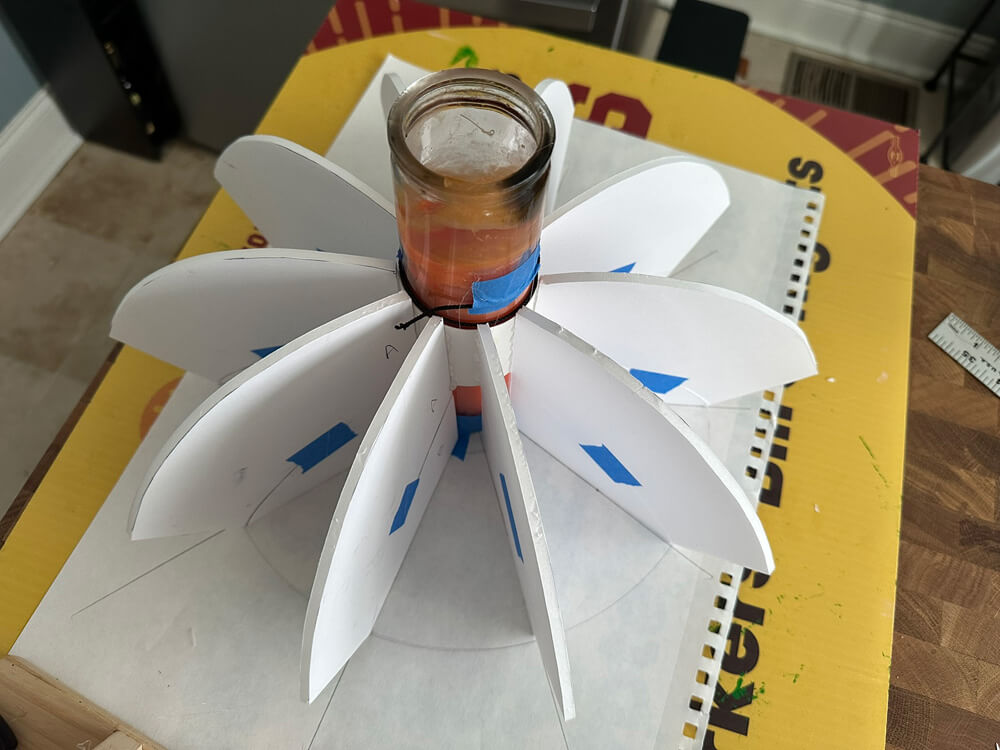 The foam board spokes glued in place around the candle.