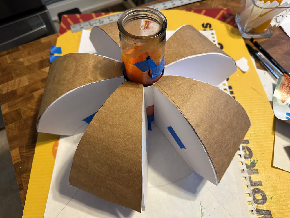 Adding pastboard wedges over top of the spokes.
