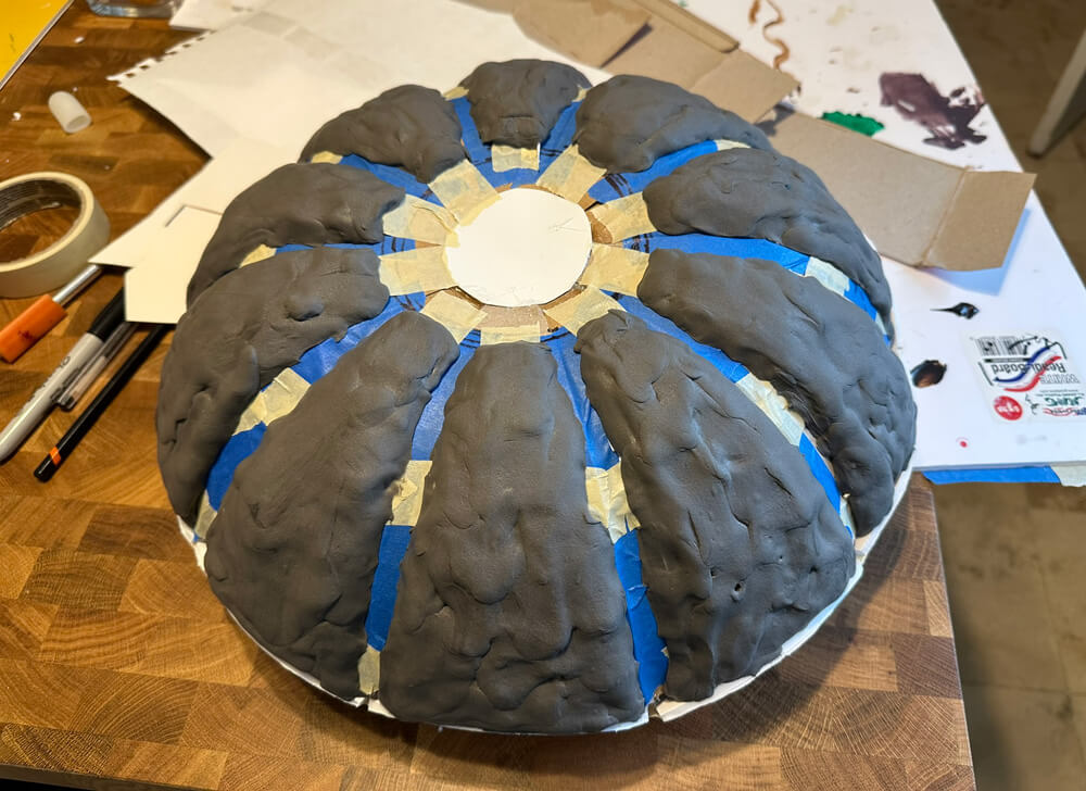 Adding gray foam clay to build up the wedge shapes.
