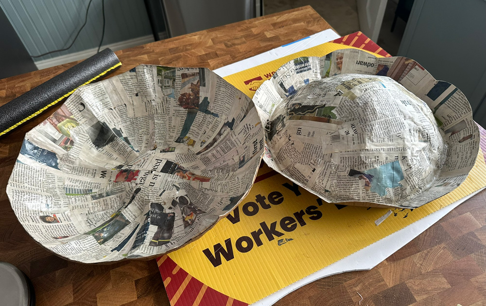 The paper mach&eacute; lid shape is split in two and hollowed out.