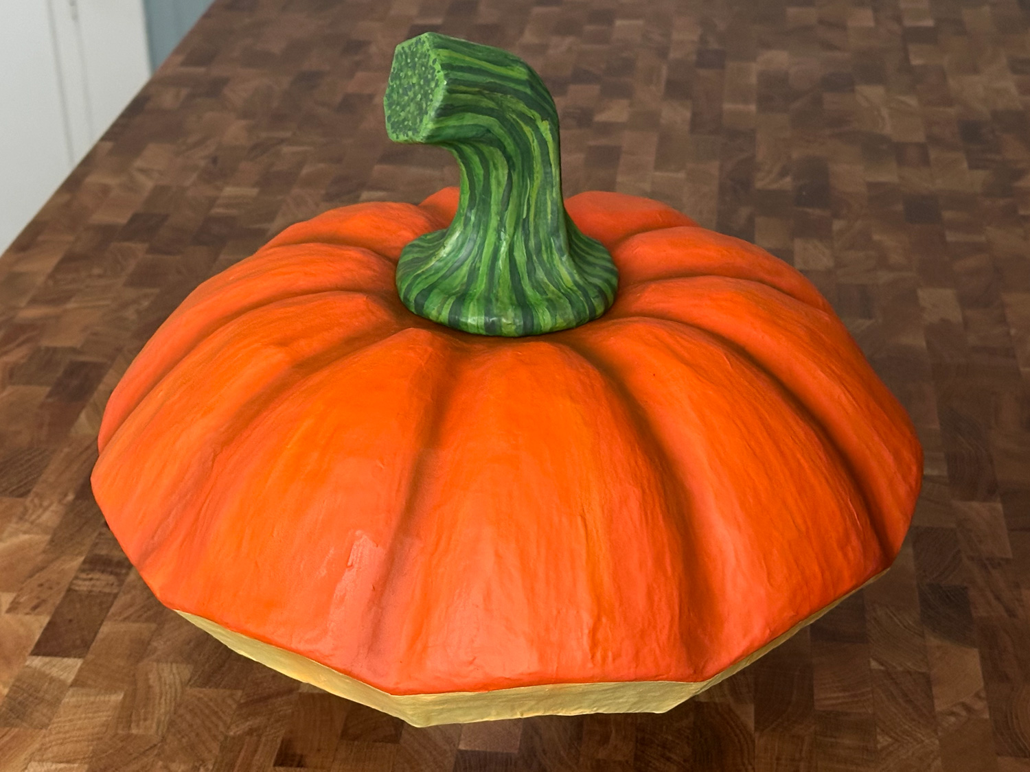 The finished pumpkin lid and stem, painted and assembled.