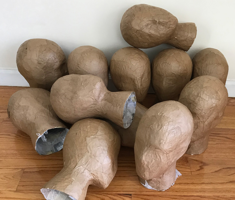 Paper mache severed heads - a dozen head bases done