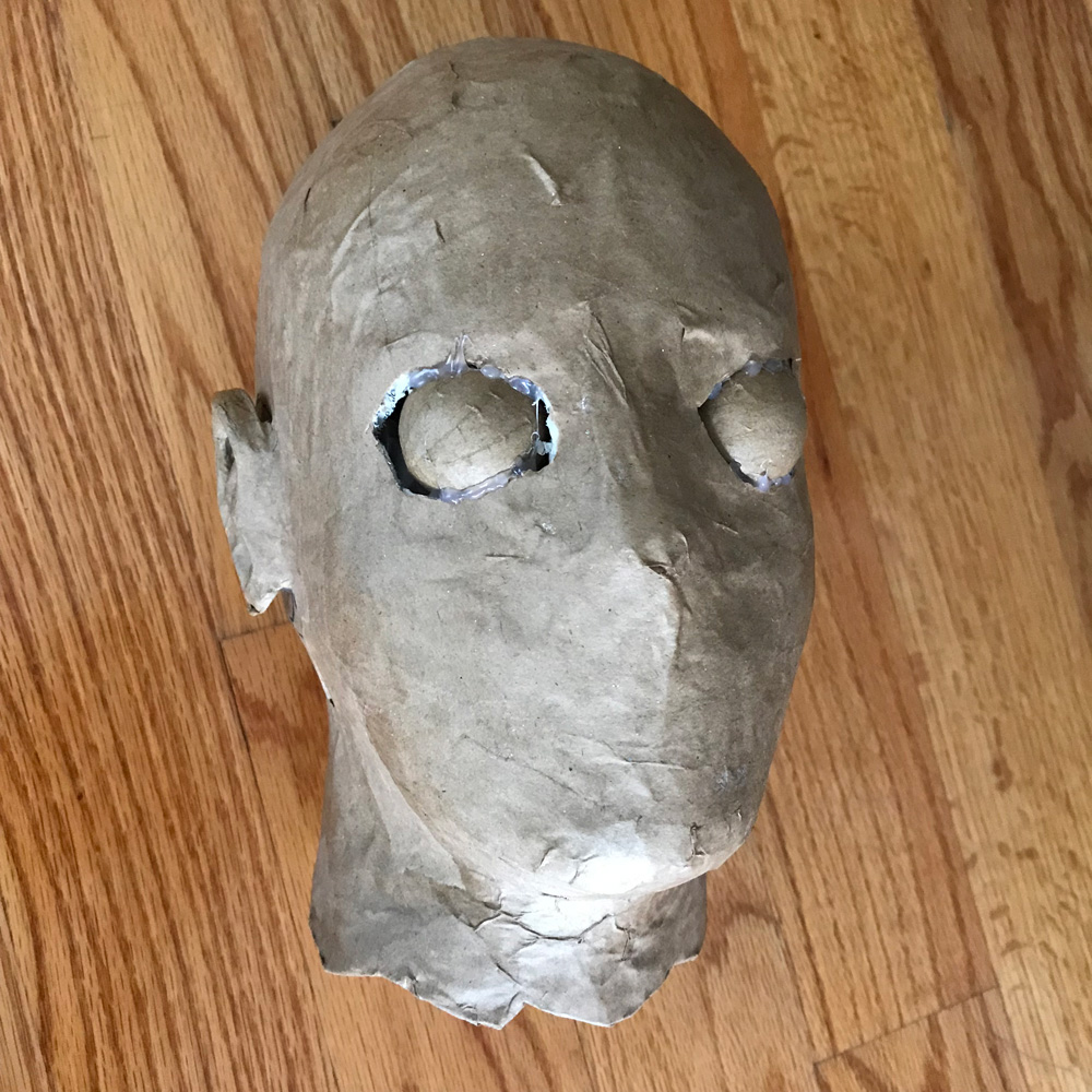 paper mache heads -- gluing eyeballs in place