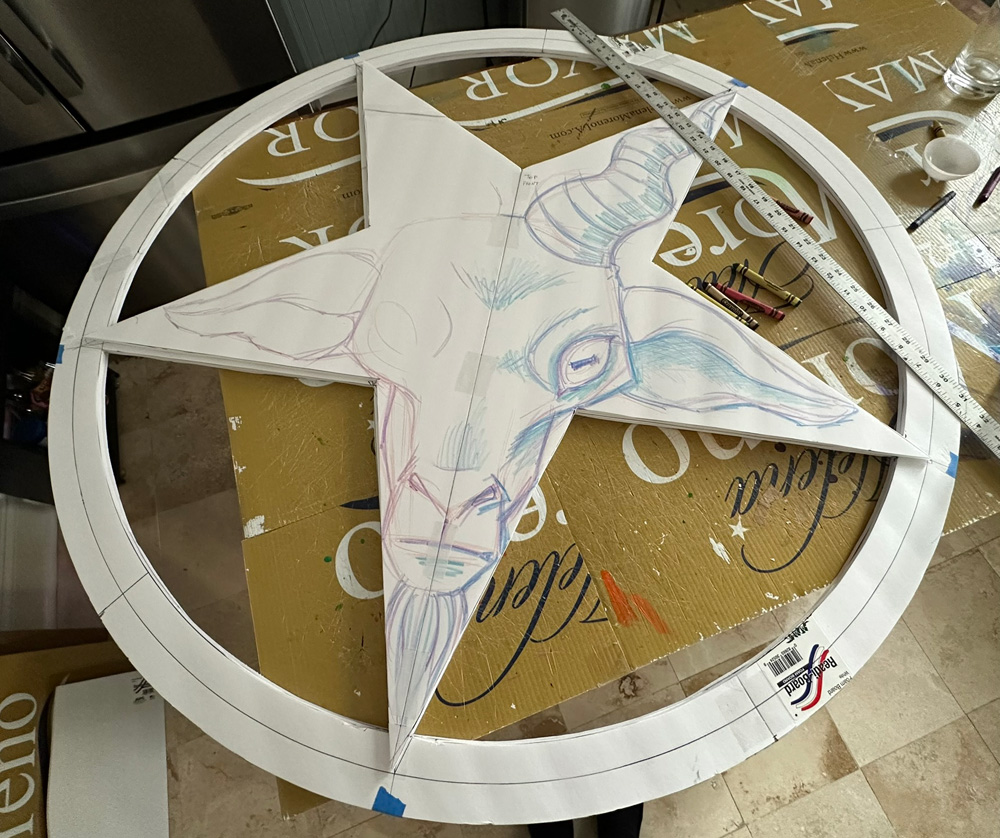 Foam board pentagram with goat head sketched on.