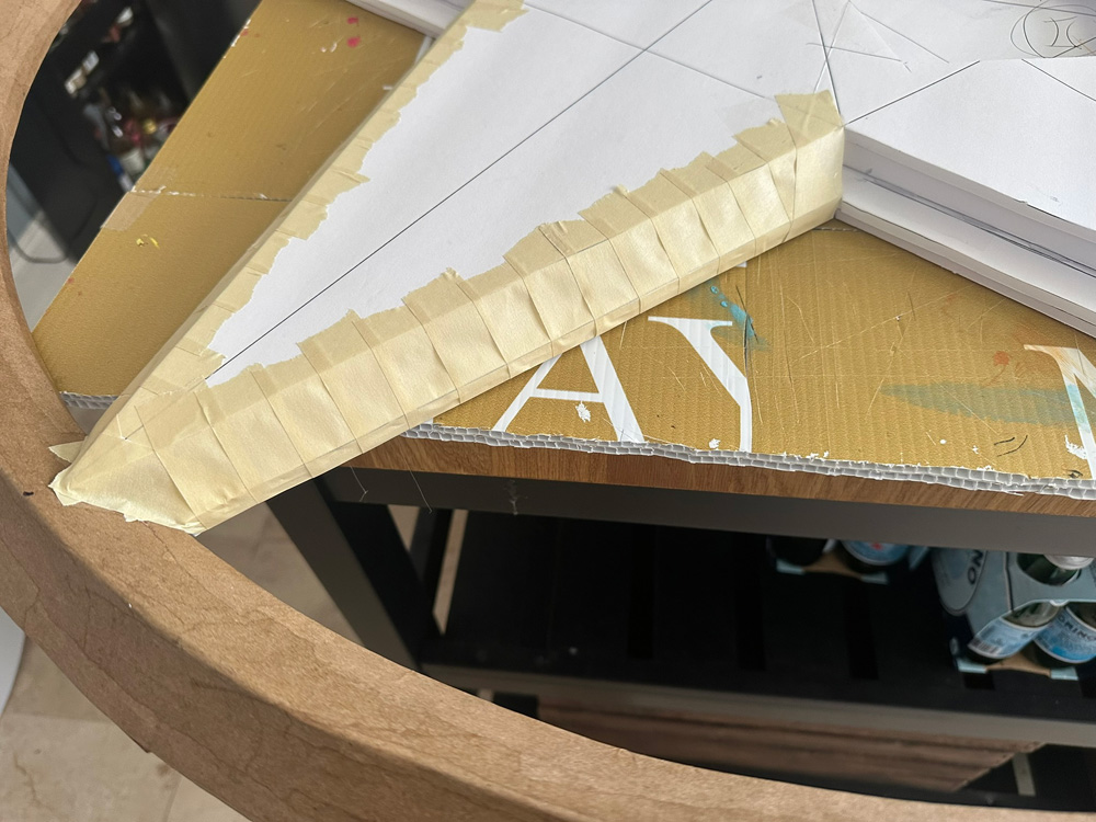 Close up of masking tape forming the 3D edges of the star.