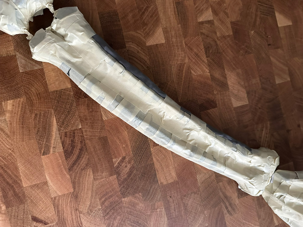 The forearm bones all padded out and covered in masking tape.